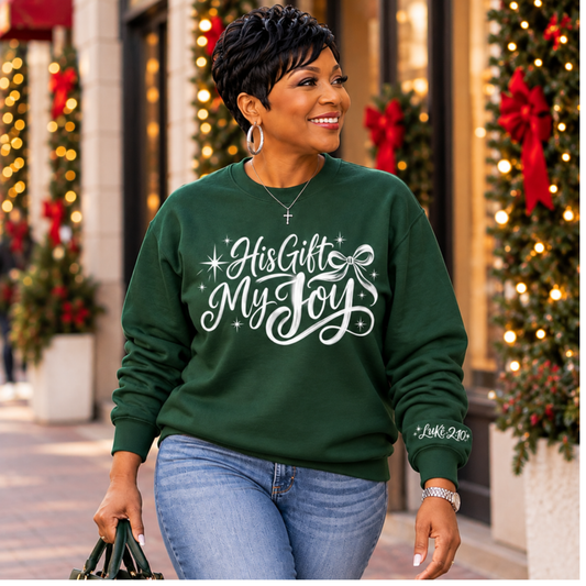 Woman wearing forest green His Gift My Joy crewneck sweatshirt on a festive Christmas street
